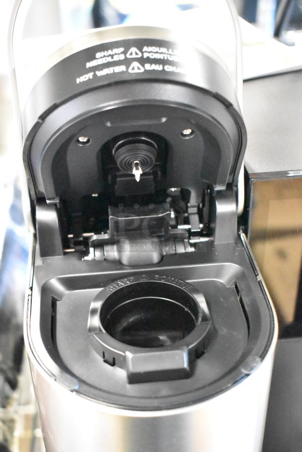 Keurig K-2550 single cup coffee machine, 115V, 1 Phase. Open top view, shows sharp needle warning label.
