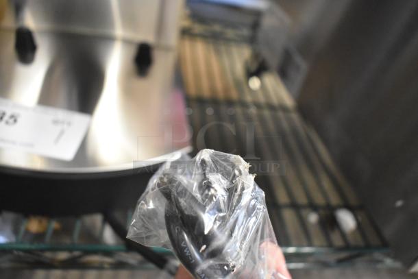 Brand new Avantco 177C15 Pourover Airpot Coffee Brewer, 120V, with visible scratch and dent. Plug shown in plastic wrap.