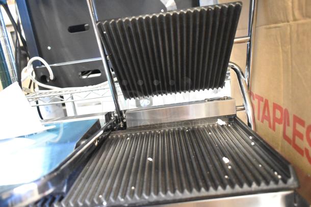 Brand new Avantco 177PG400 commercial dual panini grill with grooved plates, 19 5/8" x 9 1/8" surface, 120V.