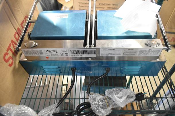 Brand new Avantco 177PG400 commercial dual panini grill with grooved plates, 19 5/8" x 9 1/8" surface, 120V, 1 phase.