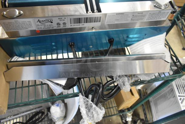 Brand new Avantco 177PG400 dual panini grill with grooved plates, 19 5/8" x 9 1/8" surface, 120V, 1-phase, scratch and dent condition.