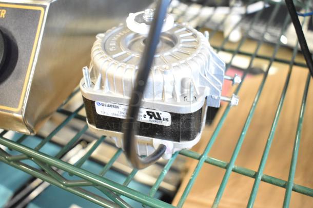 Brand new Avantco 17812245 condenser fan motor with visible model label, used for Avantco refrigeration equipment.