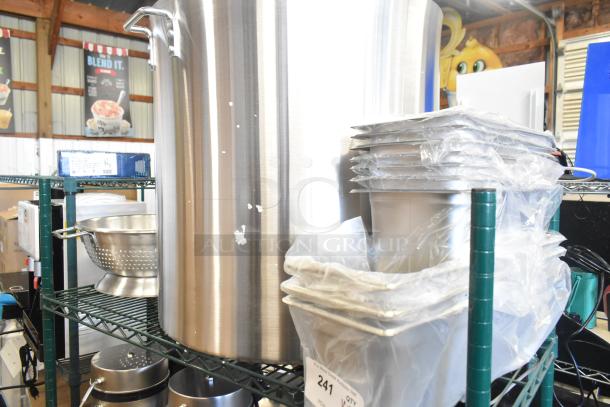 Auction items include new stainless steel stock pot and drop-in bins. Some items have minor dents. Packaged, ready for sale.