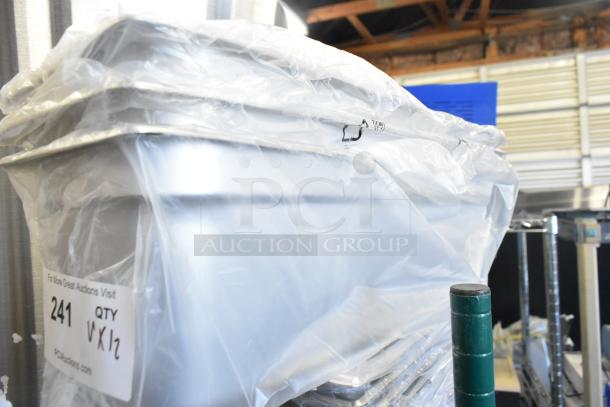Twelve brand new scratch and dent stainless steel drop-in bins wrapped in plastic with auction label "241 QTY 12".