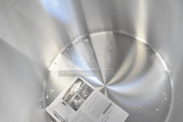 Stainless steel stock pot with minor scratches, includes manual. Part of a lot of 12 new scratch and dent items.