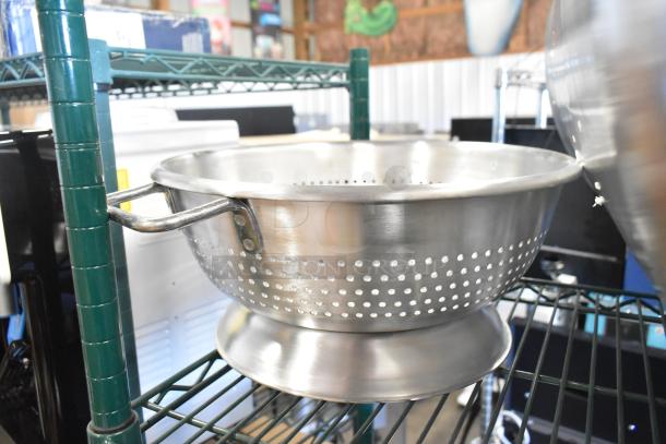 Stainless steel perforated bowl on metal shelf, new condition. Part of 12-piece scratch and dent lot including drop-in bins.