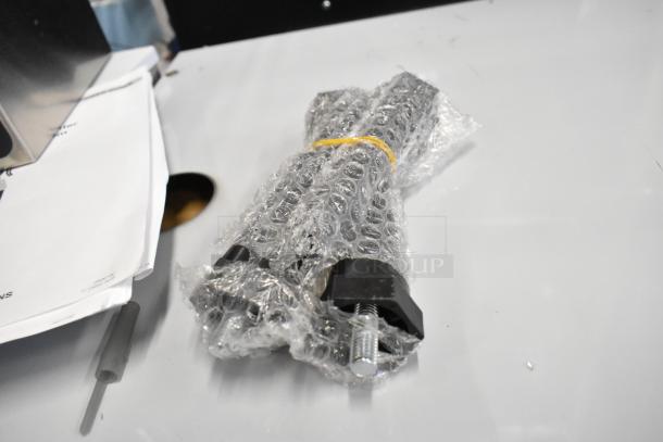 Curtis ALP1GT12A000 coffee brewer accessory wrapped in bubble wrap on a table, next to instruction papers.