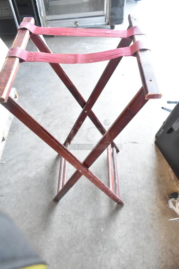 BRAND NEW SCRATCH AND DENT! Serving tray stand with wooden frame and red fabric straps, minor surface imperfections visible.