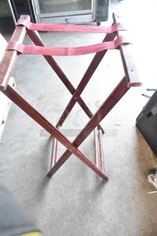 BRAND NEW SCRATCH AND DENT! Serving tray stand with wooden frame and red fabric straps, minor surface imperfections visible.