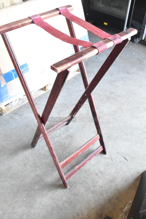 BRAND NEW SCRATCH AND DENT! Wooden serving tray stand with maroon straps, foldable design, minor surface marks.