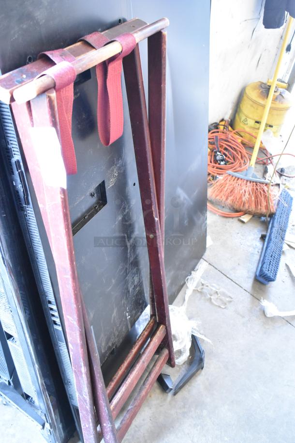 Brand new serving tray stand, dark wood finish. Scratch and dent condition, red straps attached, label visible.