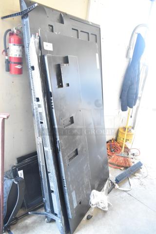 Four televisions including Samsung QN77S90FDF 77", Samsung UN75U7900FD 75", and Vizio, stacked upright. Buyer pickup required.