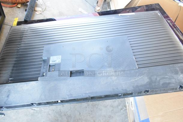 Back view of a large flat-screen TV, Samsung model label visible. Includes 4 TVs: Samsung QN77S90FDF 77", Samsung UN75U7900FD 75", Vizio. Buyer pickup only.