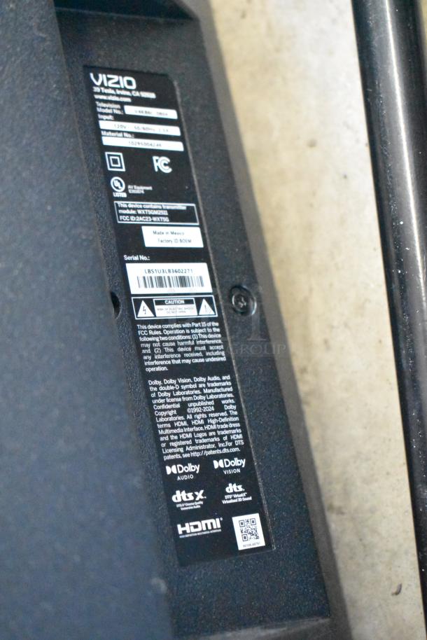 Back label of Vizio TV detailing model number, input specs, FCC compliance, and audio features like Dolby and DTS audio.