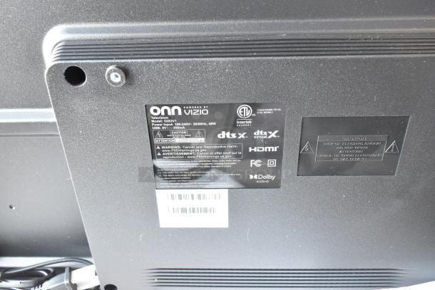 "Back of Onn 32S2V1 32-inch TV showing labels indicating HDMI, Dolby Audio, and model details. Part of a 3-TV auction lot."