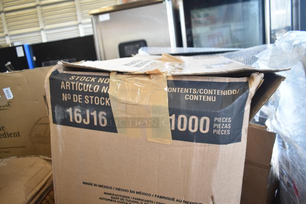 Box of scratch and dent items labeled "16J16" and "1000 pieces," including a pot rack and table base columns.