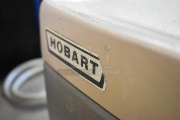 Hobart 2912 Semi-Automatic Meat Slicer, commercial-grade, 115 volts, 1 phase, visible Hobart logo, excellent condition.
