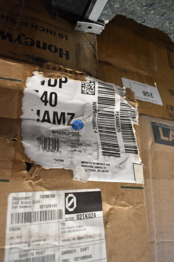 Cardboard box with Whirlpool WDP540HAMZ 24" dishwasher label, showing wear. Item is scratch and dent but brand new.
