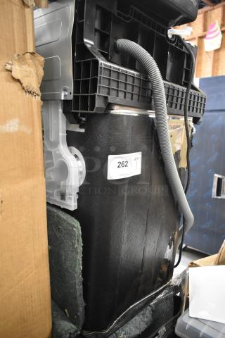 Brand new scratch and dent dishwasher, visible cardboard and protective wrapping, tag with item number 262.