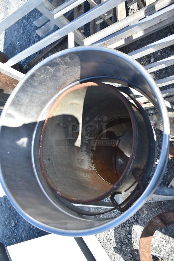 Stainless steel mixing bowl on a dolly, showing wear and minor rust inside, suitable for commercial kitchen use.