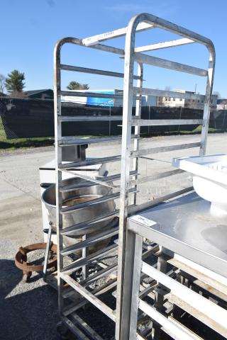 Channel Metal Commercial Pan Rack on casters, visible wear, multiple shelf slots, label indicates "Channel."