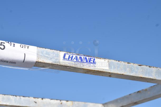 Channel metal commercial pan rack with casters, showing manufacturing label and slight wear, suitable for heavy-duty use.