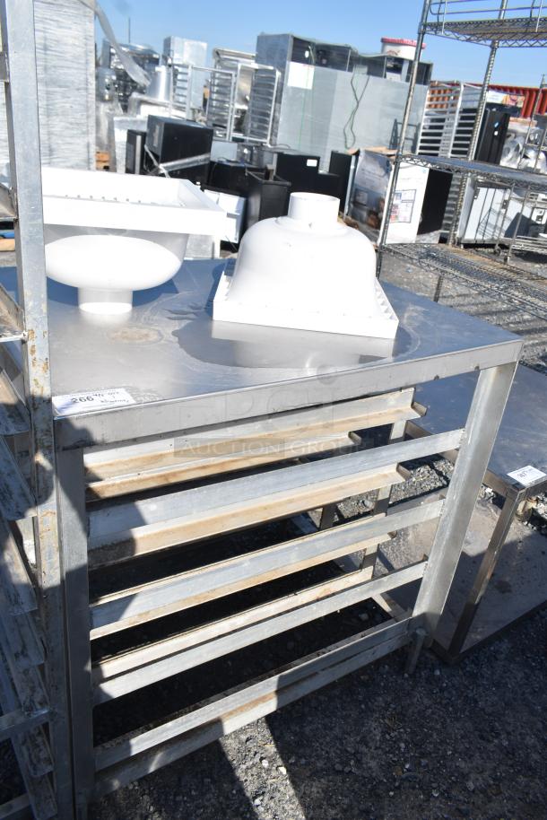 Commercial pan rack with contents shown outdoors. Metal construction with visible wear. Label indicates lot number 206.