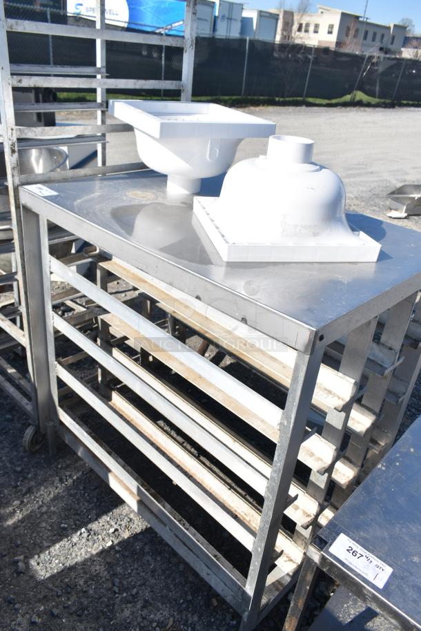 Commercial pan rack with contents, featuring multiple shelves and a stainless steel top. Includes white plastic components. Appears in used condition with visible wear. Tag reads "267".