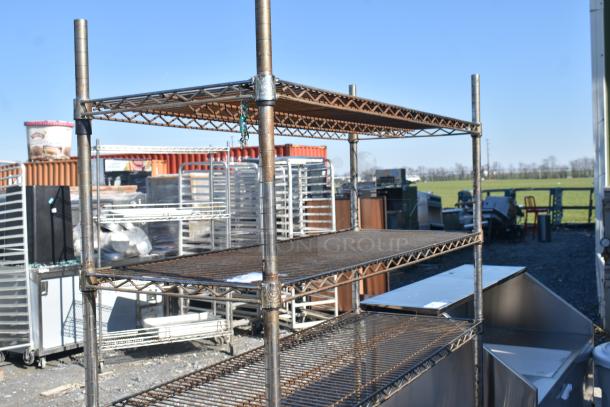 Chrome Finish 6 Tier Wire Shelving Unit, outdoor setting, used condition, buyer must dismantle, freight charges applicable.