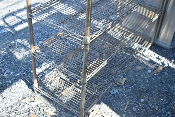 Chrome finish 6-tier wire shelving unit, good condition, requires dismantling for shipping. Consider freight charges.