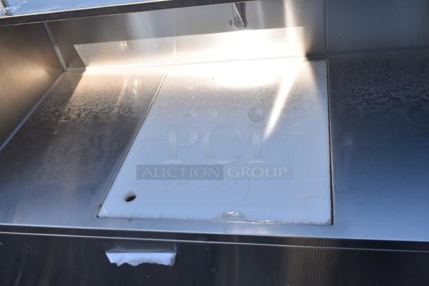 Regency 48" stainless steel portable bar, features two removable speed rails, ice bin, and cover; scratch and dent condition.