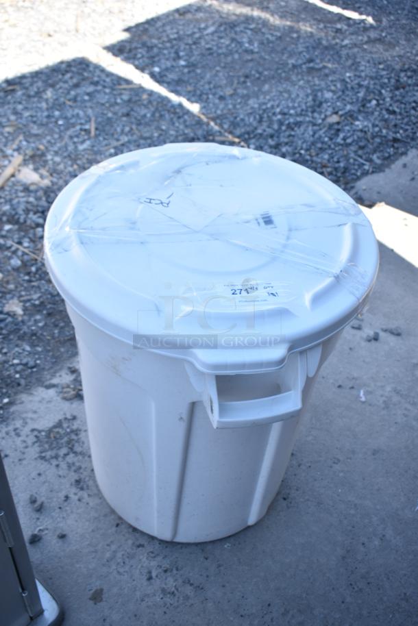 Rubbermaid Brute white poly trash can with lid and dolly, brand new with minor scratches and tape.
