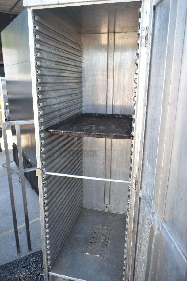 Commercial enclosed pan rack with metal interior and sliding shelf on commercial casters. Suitable for bakery use.