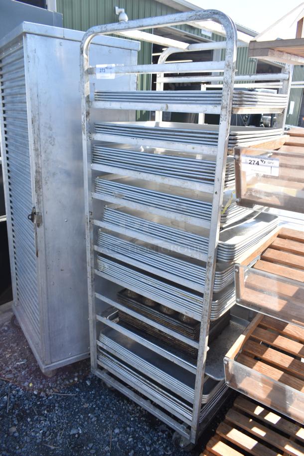 Channel commercial pan transport rack with casters, holds 50 baking pans; sturdy metal construction, visible wear.