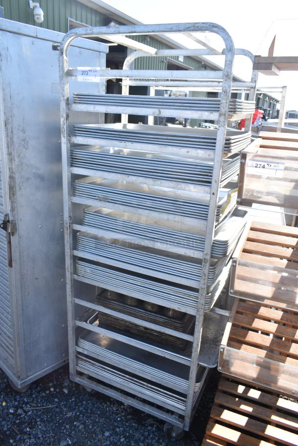 Channel commercial pan transport rack with 50 baking pans on casters. Used condition; ideal for bakery storage and transport.