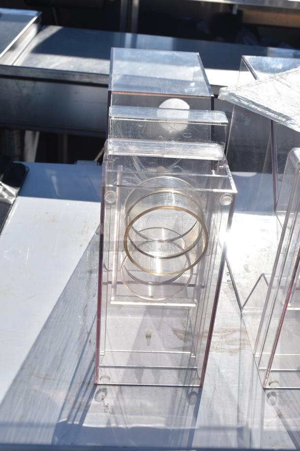 Clear acrylic hopper with round metal rings and hinged lid, showing minimal wear. An auction item offering 3 sets.