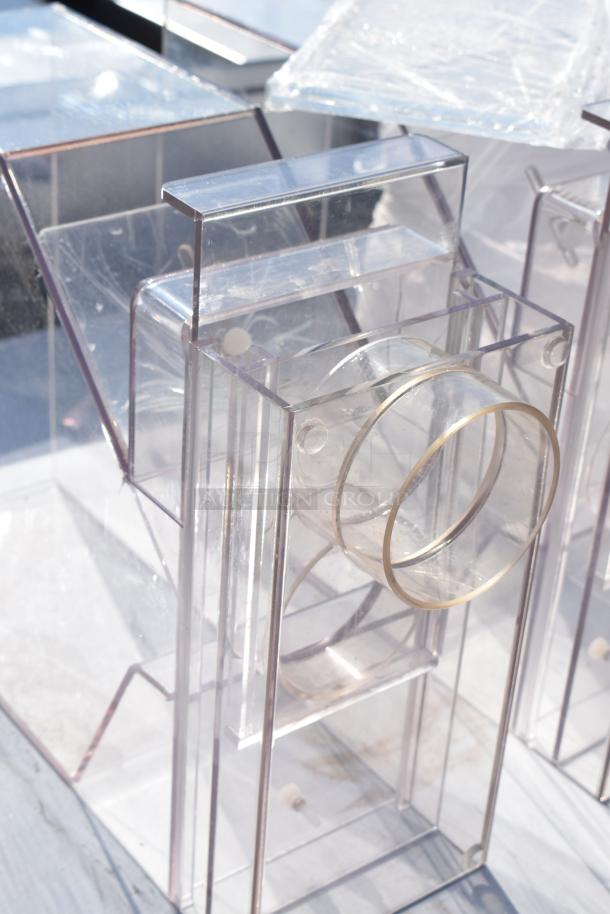 Set of three transparent acrylic hoppers, good condition, featuring cylindrical openings. Auction includes all three for one bid.