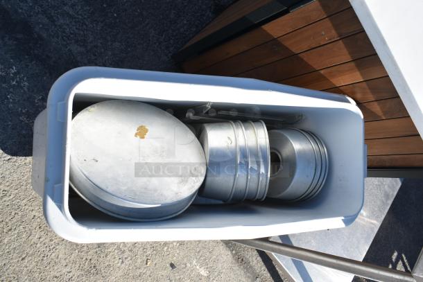White poly ingredient bin on casters containing round cake pans, good condition, ideal for commercial kitchen use.