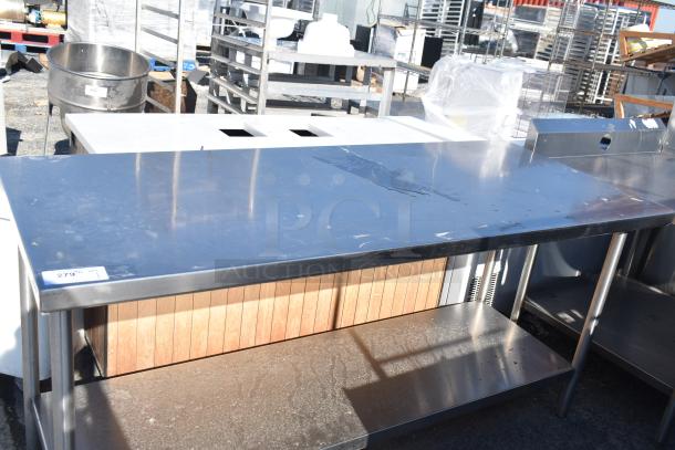 Commercial stainless steel table with under shelf, appears in good condition. Tag reads "279".