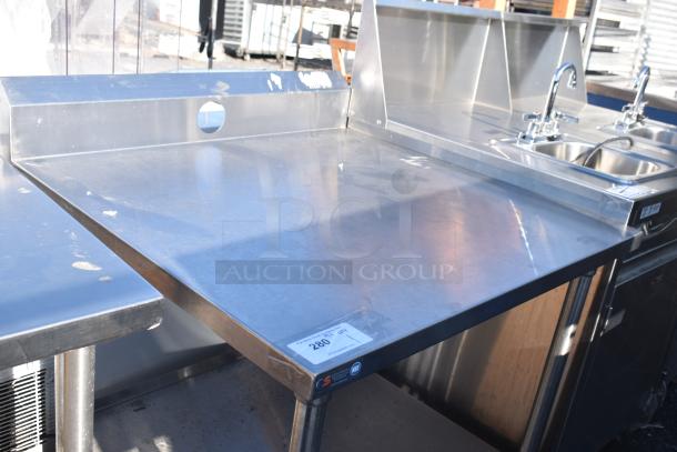 Stainless steel commercial table with under shelf, side splash, and visible wear. Marked with a tag indicating "280 QT."