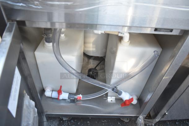 QualServ WMSC24MS commercial portable sink showing interior tanks, hoses, and valves, mounted on durable casters.