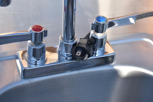 QualServ WMSC24MS portable sink with chrome faucet handles, red and blue indicators, and power plug, on commercial casters.