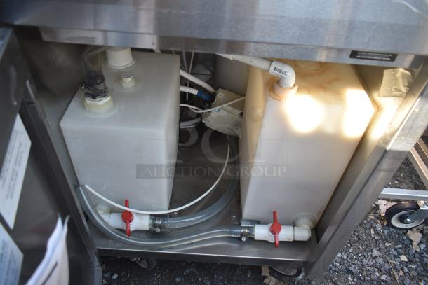 QualServ WMSC24MS portable sink with dual tanks, visible tubing, commercial casters, and control valves; good condition.