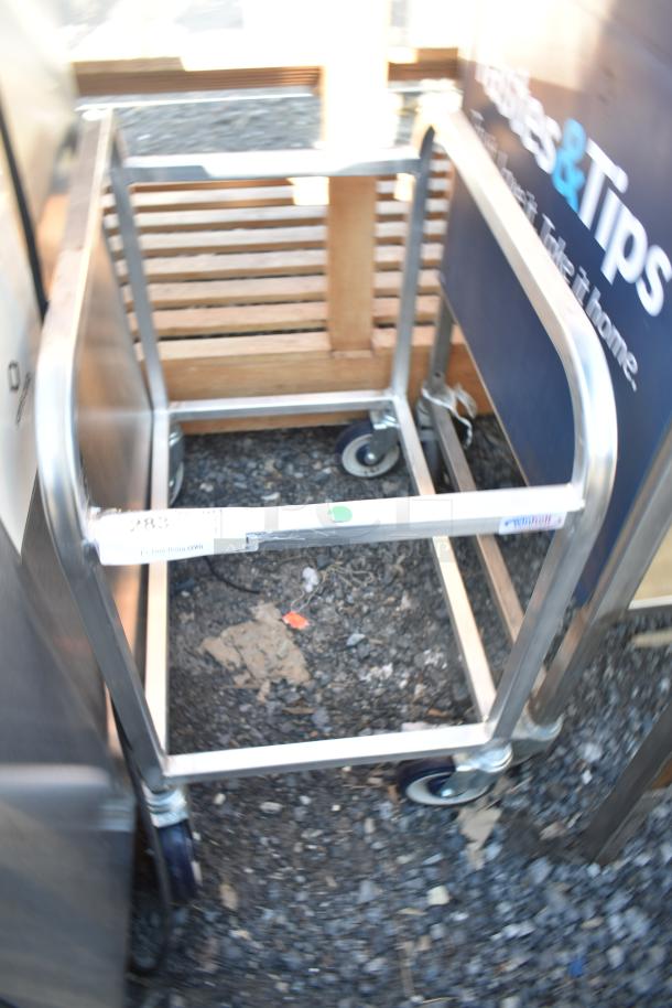 Winholt commercial pan rack on casters, metal frame, wood slats, sturdy design, used, visible tag and signage.