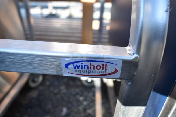 Winholt commercial pan rack with sturdy frame and commercial casters, marked with Winholt Equipment logo, in good condition.