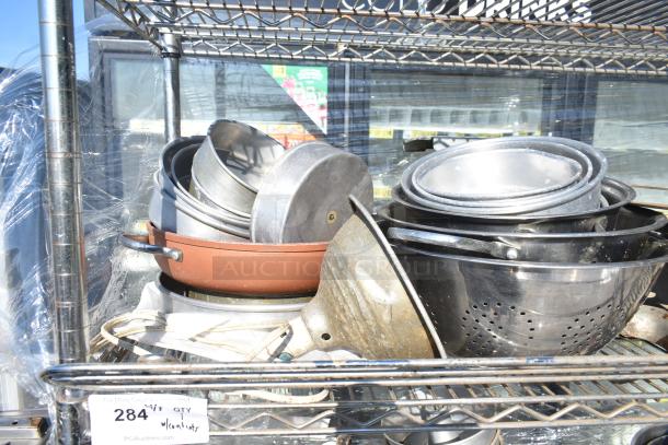 Chrome 4-tier wire shelving unit on wheels with various metal containers. Includes note on dismantling and freight charges.