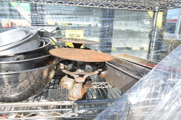 Chrome finish 4-tier wire shelving unit on commercial casters with assorted kitchen contents, visible wear. Buyer must dismantle.