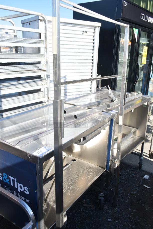 Commercial portable counter with under shelf and drawer on casters. Metal construction, durable, suitable for various uses.