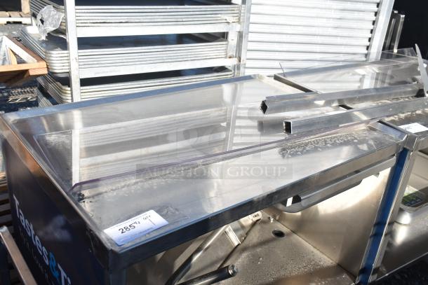 Commercial portable counter with under shelf, drawer, and commercial casters. Metal construction, tag reads "285".