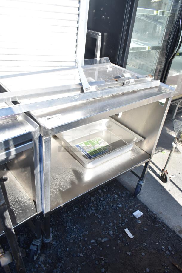 Commercial portable counter with under-shelf, drawer, and commercial casters; stainless steel construction.
